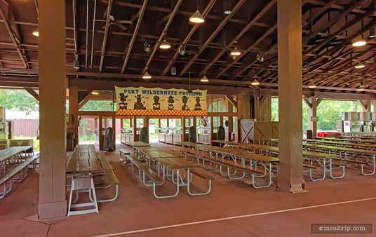 The food and beverage tables are usually located along the back wall of this photo, on the opposite side of the room that the main stage is on.