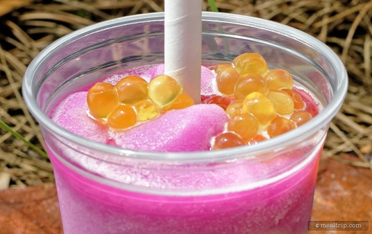 A closer look at those gorgeous passion fruit filled boba pearls! They're just the right size to make their way through the oversized straw and "pop" in your mouth.