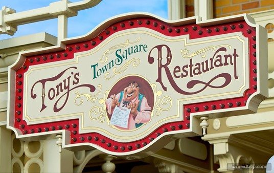 Tony's Town Square sign high above Main Street facing the City Hall building.
