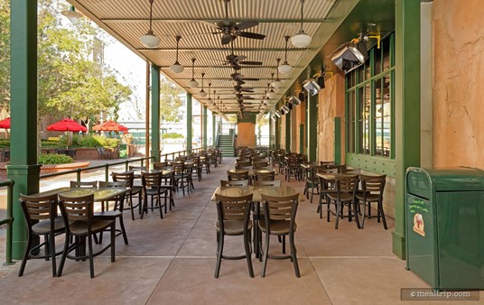 There is outdoor seating available at PizzeRizzo. Here, we are close to the front door and looking north west down the full length of the seating area. This is the ground floor of a two level seating area.