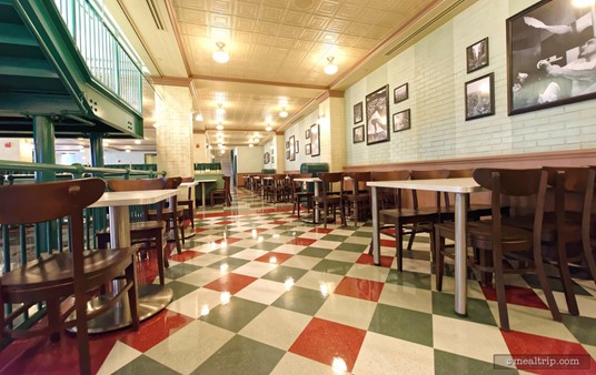 The indoor seating areas at PizzeRizzo are all very well designed. The area on the ground level, near the stairs kind of reminds me of a deli. There are black and white period photos hanging on the white wahsed brick wall.