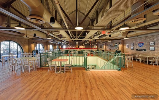 After going up stairs, the decor at PizzeRizzo changes. Note the wood floors throughout most of this area and the open rafters.