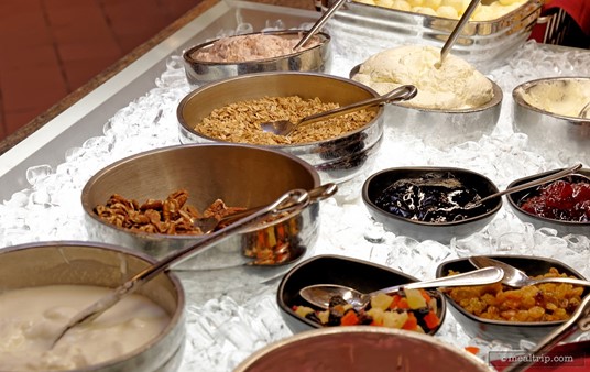 At Akershus' breakfast buffet, you will find an assortment of yogurt and toppings including fresh granola along with fresh and dried diced fruit.