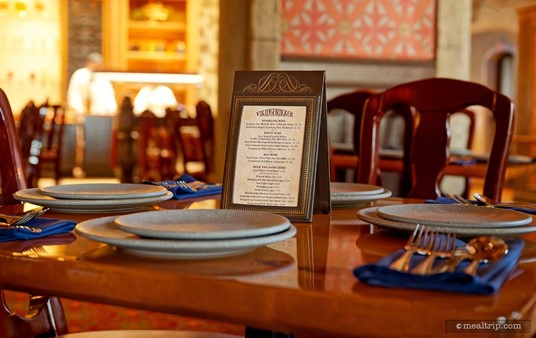 Here's a quick look at a typical table setting at Akershus. There's an "adult beverage" menu on the table, along with a couple of plates, blue cloth napkins, and a full set of flatwear.