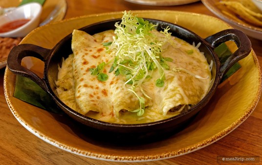 The Just-made tortillas, creamy roasted tomatillo sauce, and pea shoot and frisée salad are featured in the Grilled Zucchini, Mushroom, and Potato Enchiladas.