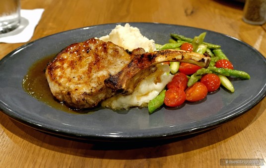 You'll find this Pork Chop on the "From the Land" section of the Paddlefish menu. It's accompanied by an asparagus and split tomato medley, some blue cheese mash potatoes, and an apple cider reduction.