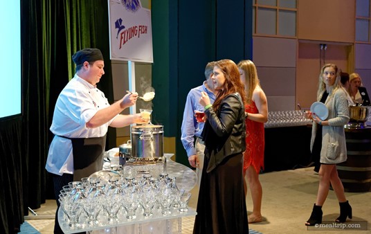 So you just walk up to any of the culinary stations, and they will make and plate the item that's on the menu. Each station has a sign, letting guests know which restaurant they are from. Here a Flying Fish chef creates their dish for the night, Rock Shrimp with Tillamook Cheddar Grits in a Martini Glass!