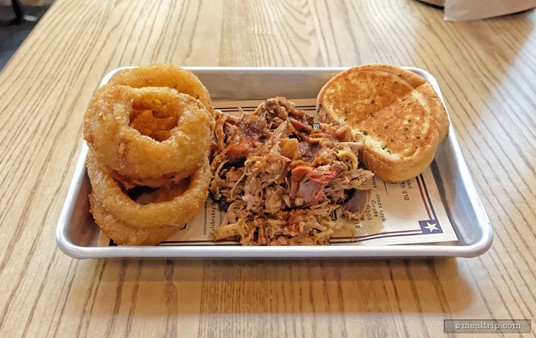 The North Carolina Chopped Smoked Pork Butt Platter features chopped pork butt topped with North Carolina Vinegar Sauce and is served with Garlic Toast. Most of the entrees also come with a "side item". Pictured here, are the beer-battered onion rings.