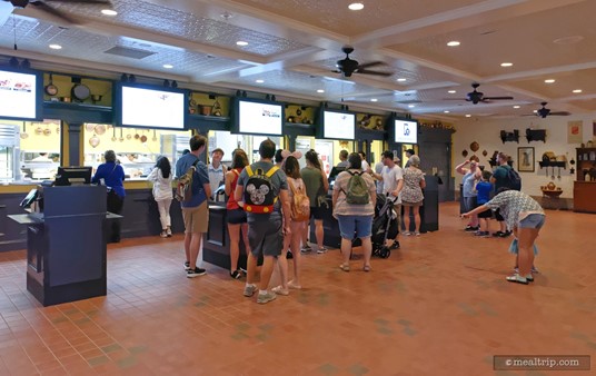The Regal Eagle Smokehouse utilizes a familiar "order/payment teller" system, with the food pickup area just behind. Each "teller/cast member" serves the left and right side of their booth. Once you place your order (and pay for it), you only have to take a few steps forward, and pick up your food.