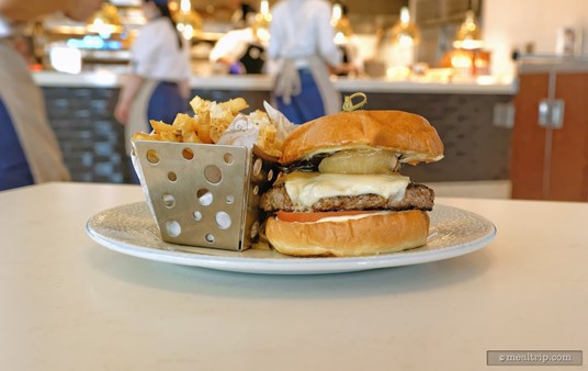 This is the Riviera Burger with fries. It's a beef patty burger and features a grilled portobello top, swiss 
cheese, caramelized onions and a tomato, all between a brioche roll. 
It's served with a side of fries that have been dusted with parmesan 
cheese and herbs.