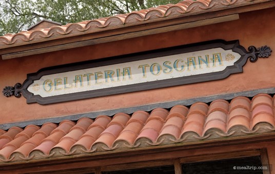 The thin sign about the Gelateria Toscana gelato building.