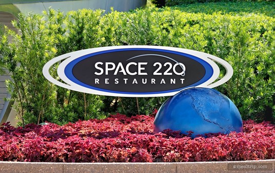 The exterior sign near the main entrance to Space 220 is located in the same courtyard as the Mission: SPACE attraction.