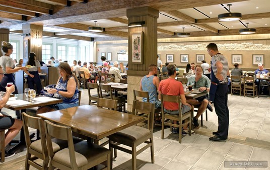 The ceiling seems low, but that might be an optical illusion caused by the decorative beams. The tables are moderately spaced. You probably won't back into someone when getting in or out of your chair, but the tables are close in "side by side" terms.