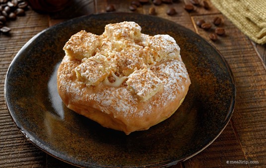The Cinnamon Coffee Cake donut features cinnamon icing and is topped with coffee cake cinnamon crumbles, cream cheese drizzle, and powdered sugar.