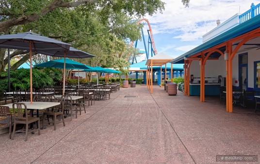 If you're looking directly at the front of Altitude Burgers, this seating area can be found on the left-hand side of the restaurant. The umbrella covered tables on the far left are popular and offer a good view of the Ice Breaker track in the background.