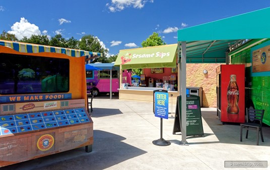That small orange "truck" (now on the left), only looks like a truck on the other side and front. A closer look from this side reveals a food-related activity/game. It is not a food ordering station.