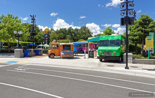 If you're walking from the west side of the park, you'll probably see the green "ABC Eats" truck first. That little orange truck in the center, is game/activity screen, and doesn't actually offer any food items.