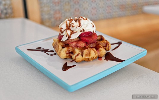 This Liège Waffle is described as being a brioche dough waffle with pearl sugar, strawberries, whipped cream and chocolate sauce.