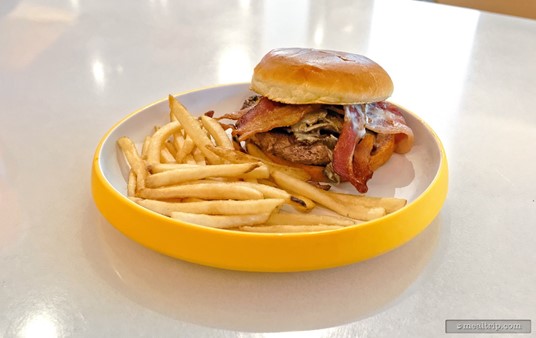 The French Bistro Burger which features a blended beef burger patty, caramelized onions, bacon, brie, mushrooms, dijon mayonnaise, and a toasted brioche bun.