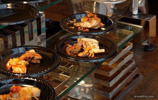 A couple of plates are made ahead of time and kept under heat lamps on the front side of each of the culinary stations. They don't stay too long there though — guests are usually taking these sample plates just as quick as the chefs can put them out there.