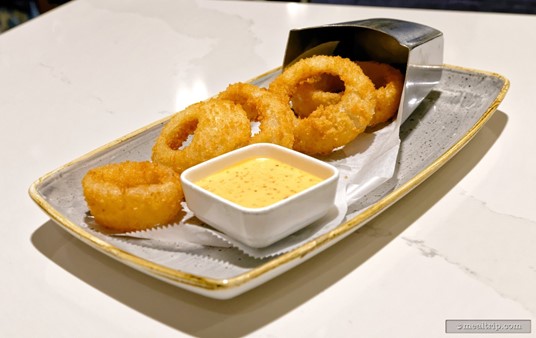 The Onion Rings at Steakhouse 71 are said to be hand-breaded and served with a plant-based spicy ranch dipping sauce.