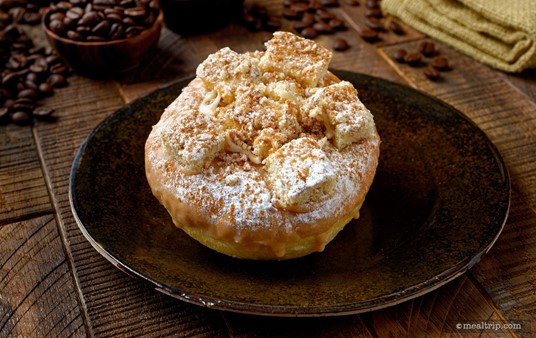 This is the "Cinnamon Coffee Cake Donut" features cinnamon icing and is topped 
with coffee cake cinnamon crumbles, cream cheese drizzle, and powdered 
sugar. Contrary to "cake" being in the name, it's actually a fried donut... the "Coffee Cake" is crumbled on the top.