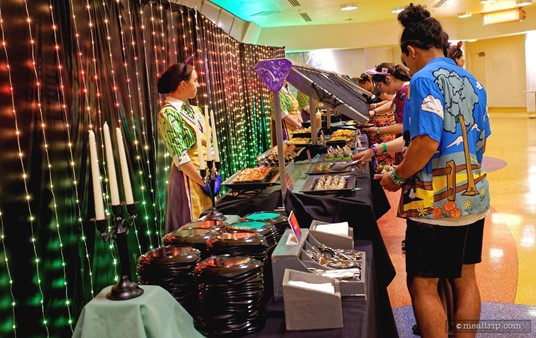The buffet line at Disney's Not-So-Spooky Spectacular Dessert Partyworks works just like a buffet line at any of the Disney restaurants. At the far left and right side of the main buffet, there's plates and silverware. Guests can pick up a plate and work their way to the center, where there's a featured "warm dessert item" that both sides can access. The left and right sides feature the same dessert items.