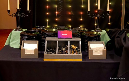 This is one of the "plate, utensils and napkins" tables at Disney's Not-So-Spooky Spectacular Dessert Party. There's two of these tables — one on the far left and one on the far right of the main buffet line.