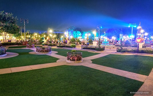 In this photo of the Not-So-Spooky Spectacular Dessert Party Plaza Garden Firework Viewing area (that's a lot of typing) — the castle is just outside of the frame (far right) where the blue light is emanating from. You can see one of the lower castle spires in the back.