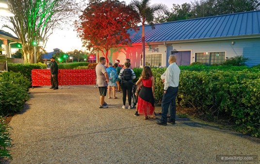 And here's a photo of everyone lining up on the walkway, waiting for "Dinner with Santa" to begin. Most of us (eventually) ended up going through those red, gift-wrapped barriers near the back of the photo — after the cast member slid them out of the way.