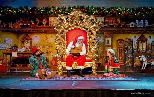 While there are some physical props on the stage, like Santa's workshop desk, his chair (obviously) and a small rocking horse — the rest of the background is a very large vinyl backdrop.