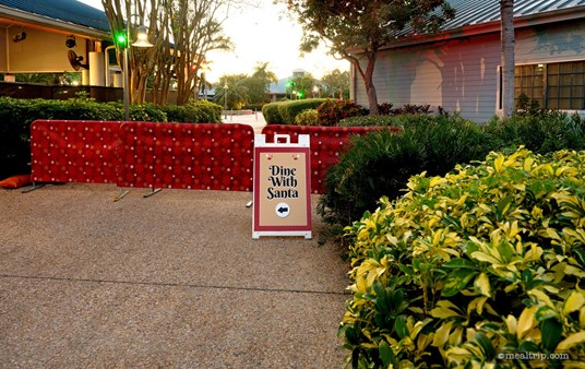 There was a sign that suggested that the "Dine with Santa" guests were supposed to go into the gift shop — but that actually turned out not to be the case. A cast member said "the gate was locked" — so guests were told to line up behind this sign instead.