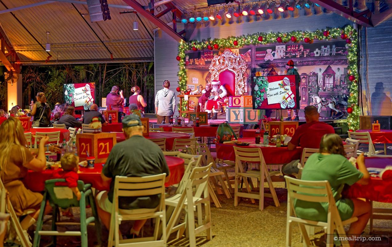 Highchairs for tiny guests are also available upon request. As you can see in the distant background of this photo — there were a couple different times over the course of the evening where guests could hop up on stage and pose for a photo with Santa.