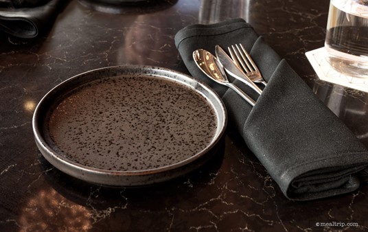 Each person at the table is given a cool little plate and flatware wrapped in a black napkin... along with a option for a glass of water (far right).