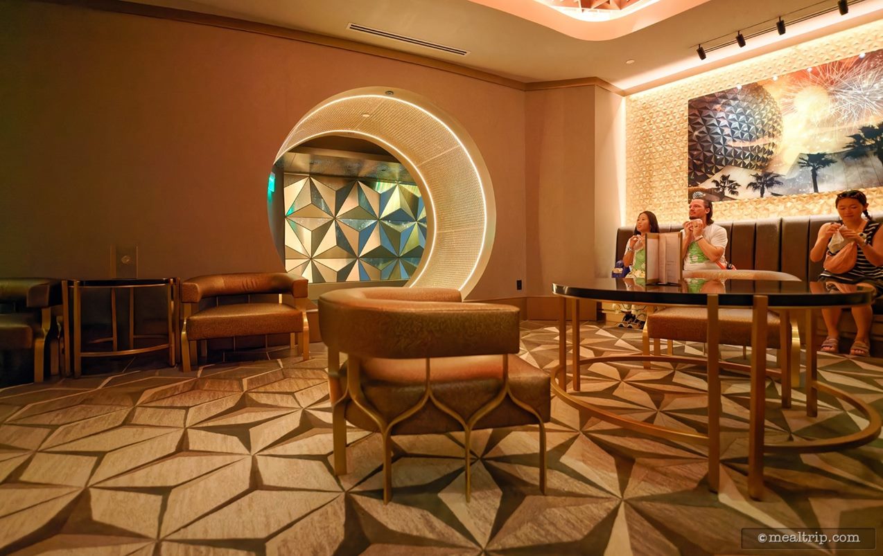 There's a small tube tunnel on one side of the room. This is the pathway that leads into the actual Geo-82 lounge area. You're asked to wait in this area until your party's name is called – at which time a cast member will lead you to your table, through the mini tunnel, into the lounge.