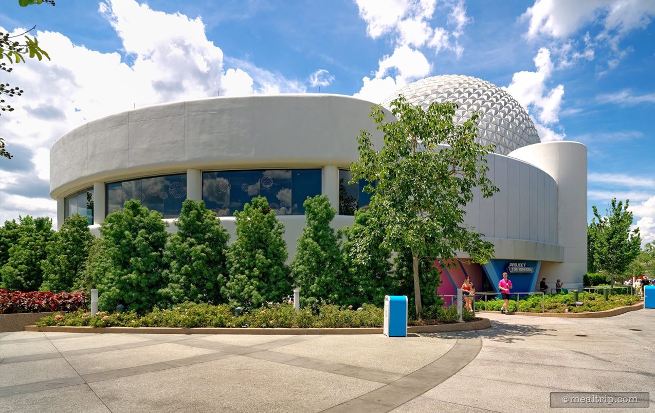 Taking a few steps back and to the side, we can start to see Spaceship Earth behind the Project Tomorrow and Geo-82 building (the lounge is on the second floor, where all the windows are located). In this photo, the entrance to the lounge (and main check-in desk), would be near a door on the far left side of the photo.