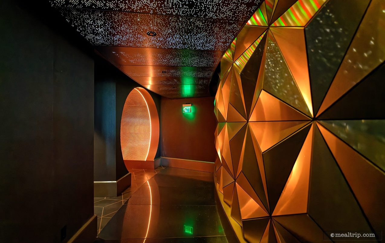 Here's a cool look at the "bathroom hallway". The entry/exit tunnel is at the back of the photo – the bathroom nook is on the left and the Spaceship Earth panel wall is on the right.