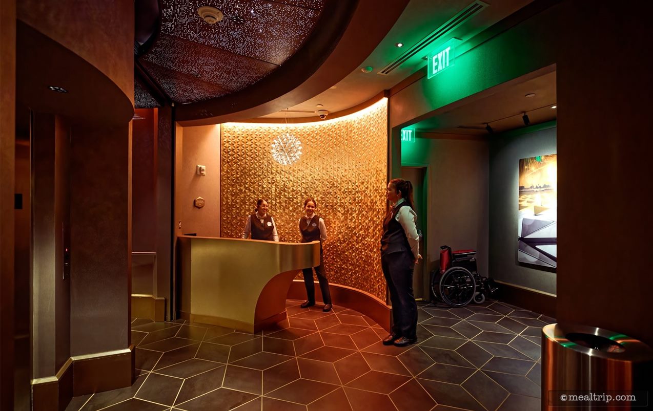 Here's a photo of the second "check-in" area, although there's no "checking in" here. One of the cast members behind this desk handed us a wet, cold towel. For now, it appears that's what the station is used for. The stairs and elevator are on the left side of the photo.