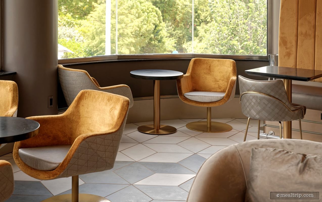 There are two tables for two next to the window - at either end of the lounge area. While not providing the perfect "center" view, it's still fun to "people watch" on the pathway down below.