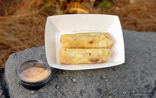The Cheeseburger Spring Rolls are served with a small cup of dipping sauce.