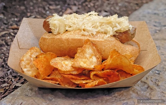 A Fresh-cooked Brat with Roll, Sauerkraut, and chips from Epcot's Sommerfest located in the Germany Pavilion.